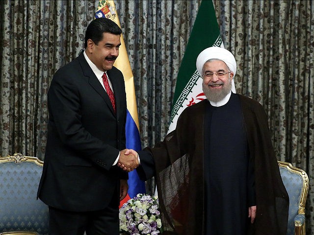 TEHRAN, IRAN - OCTOBER 22: Iranian President Hassan Rohani (R) shakes hands with Venezuela