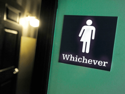 A gender neutral sign is posted outside a bathroom on May 11, 2016 in Durham, North Carolina