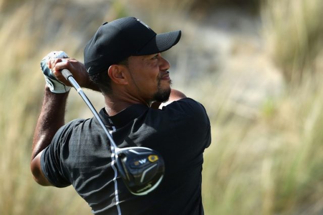 Tiger Woods of the United States hits a tee shot on the third hole during round one of the