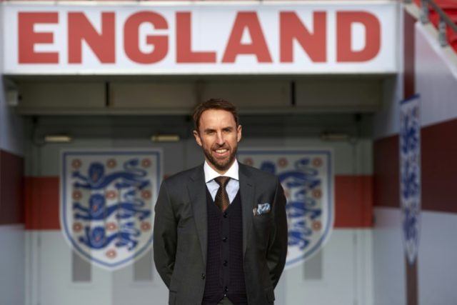 England's new manager Gareth Southgate poses for photographers during a media session at W