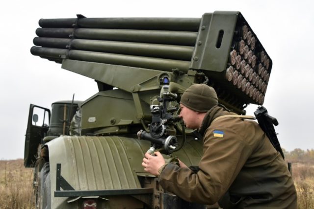 A Ukrainian serviceman aims a 122 mm MLRS BM-21 Grad during military exercises near Kiev o