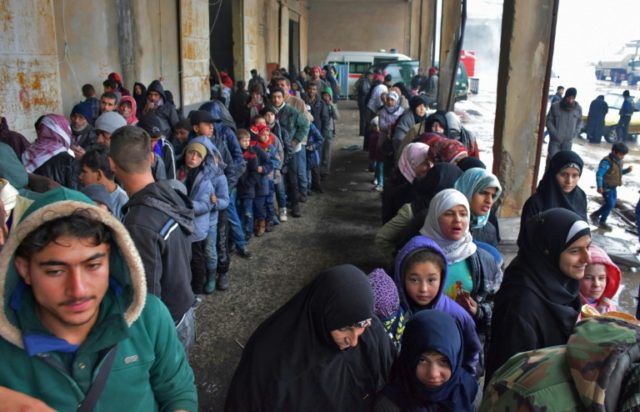 Syrians who fled from rebel-held areas in east Aleppo receive food aid on December 1, 2016