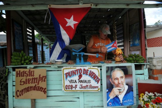 A farmer decorates his stall as he waits for the urn with the ashes of Cuban leader Fidel