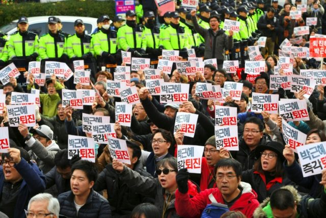 South Korean protesters shout slogans during a protest outside the headquarters of the rul