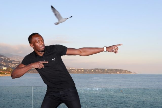 Nine-time Olympic champion Usain Bolt poses at the 204th IAAF Council meeting in Monaco on