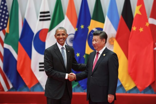 China's President Xi Jinping (R) shakes hands with US President Barack Obama before the G2