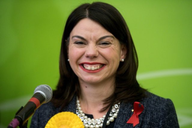 Newly elected Liberal Democrat MP Sarah Olney smiles on stage after winning a by-election
