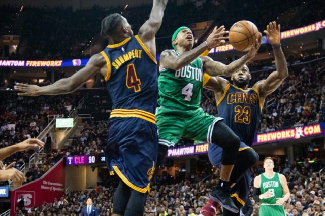 Isaiah Thomas of the Boston Celtics shoots over Iman Shumpert and LeBron James of the Clev