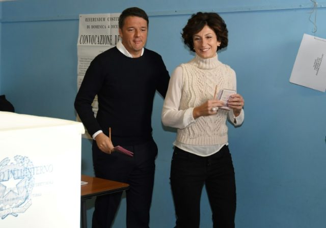 Italy's Prime Minister Matteo Renzi (L) and his wife Agnese Landini vote for a referendum