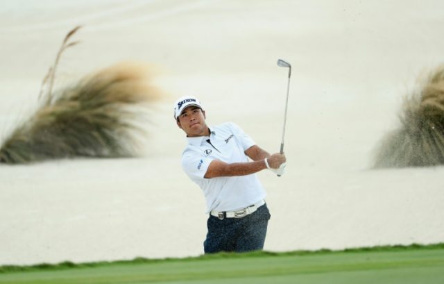 Hideki Matsuyama of Japan hits a shot from a greenside bunker on the third hole during the