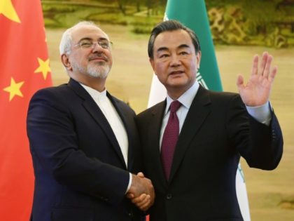 Iran's Foreign Minister Mohammad Javad Zarif (L) shakes hands with his Chinese counte