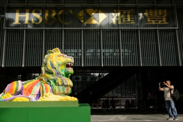 A pair of lions painted in rainbow colours are displayed outside HSBC's main office in Hon