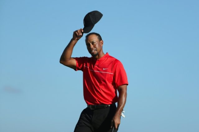 Tiger Woods of the United States tips his cap on the 18th hole during the final round of t