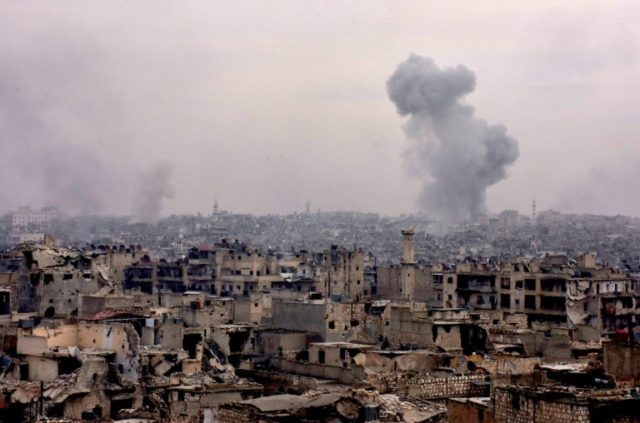 Smoke rises from buildings in Aleppo's eastern Karm al-Jabal neighbourhood on December 5,