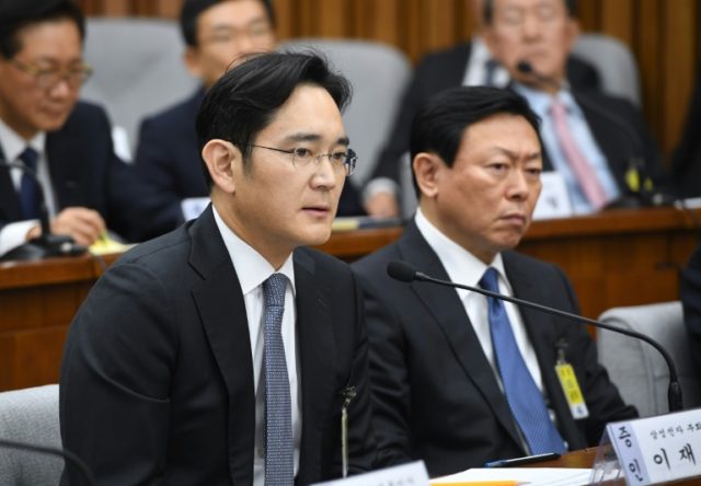 Samsung Group's heir-apparent Lee Jae-Yong (L) answers a question as Lotte Group Chairman