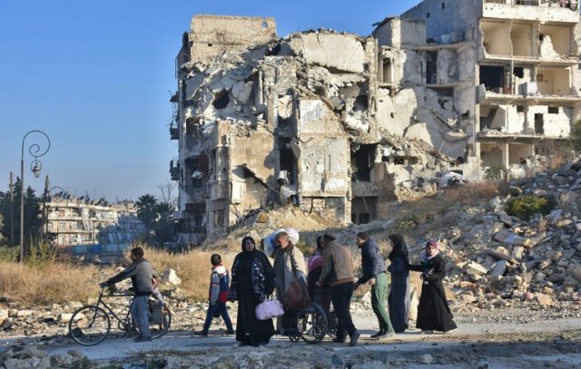 Syrian residents fleeing the violence in the eastern rebel-held parts of Aleppo evacuate f