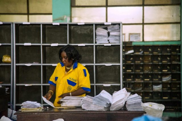 An employee distributes letters and other mail at a branch of the Congolese Company for Po