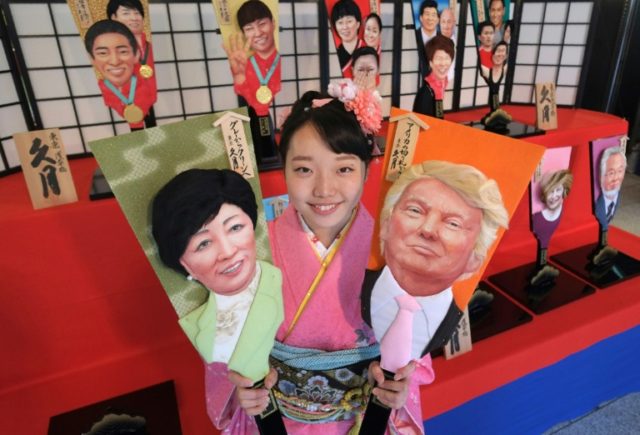 Megumi Kondo, an employee of the Japanese traditional doll making firm Kyugetsu, displays