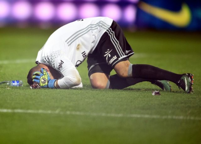 Lyon's Portuguese goalkeeper Anthony Lopes reacts after a firecracker exploded beside him