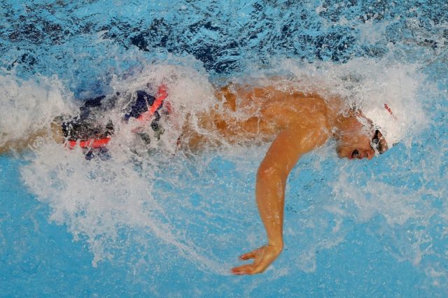 Michael Andrew of the US swims the 3rd leg of the 4x50m freestyle preliminary, on day four