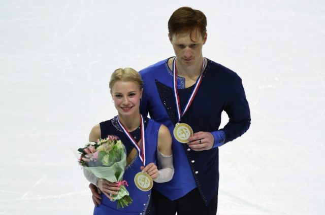 Russian's Evgenia Tarasova and Vladimir Morozov celebrate after winning the senior pairs s