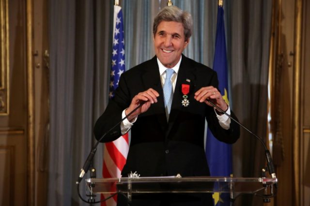 US Secretary of State John Kerry smiles after being awarded the Grand Officier de la Legio