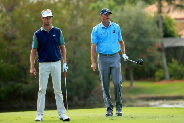 Matt Kuchar and teammate Harris English watch his tee shot on the fourth hole during the f