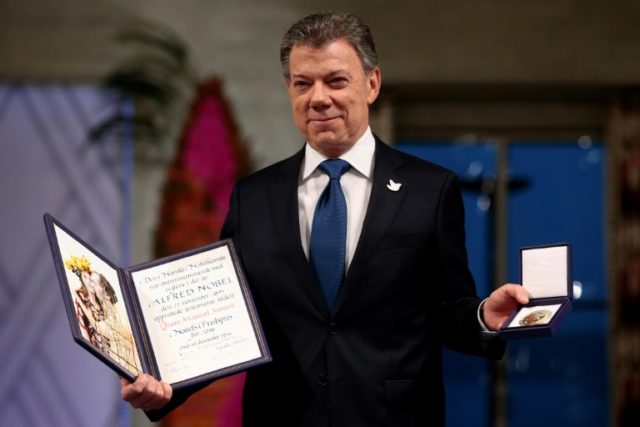 Nobel Peace Prize winner Colombian President Juan Manuel Santos poses with his award in Os