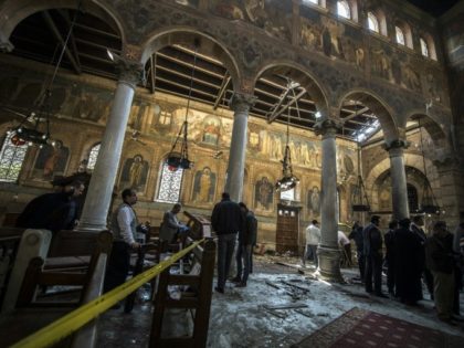 Egyptian security forces inspect the scene of a bomb explosion at the Saint Peter and Sain