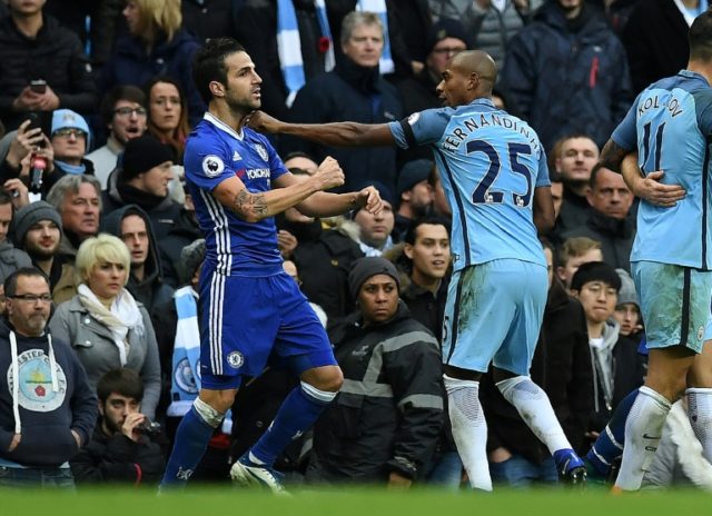 Manchester City's midfielder Fernandinho (R) fights with Chelsea's midfielder Cesc Fabrega