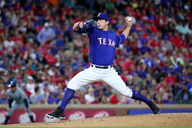 Derek Holland of the Texas Rangers pitches against the Tampa Bay Rays in the top of the ei