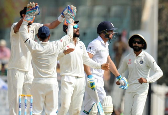 India's captain Virat Kohli (C) and teammates celebrate after the dismissal of England's J