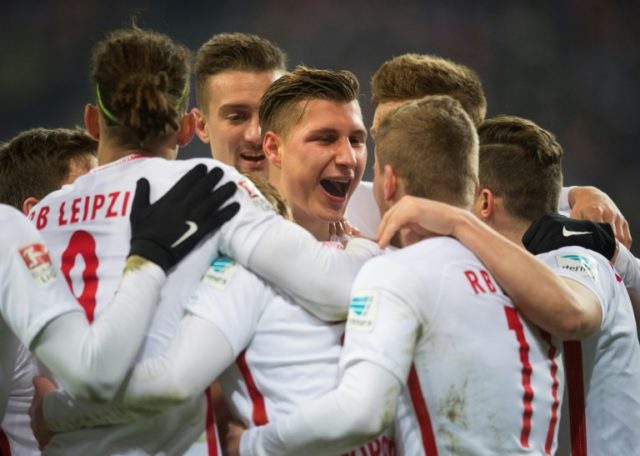 Leipzig's defender Willi Orban celebrates with teamates after scoring his team's third goa