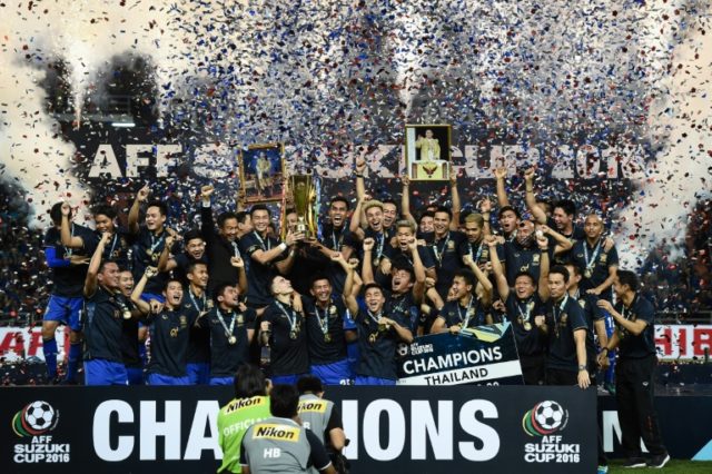 Thailand's football players lift the AFF Suzuki Cup after winning the second leg of the fi