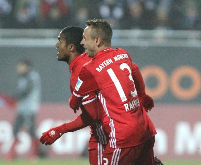 Bayern Munich's midfielder Douglas Costa celebrates after scoring with Rafinha in Darmstad