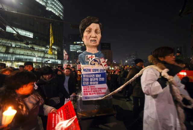 South Korean protesters carry an effigy of President Park Geun-Hye during a rally against