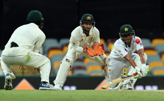 Pakistan's batsman Younus Khan (R) fails to play a reverse-sweep shot off Australia's spin