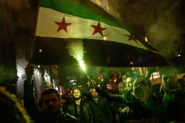 Protesters hold a Syrian flag during a demonstration against Russia in Istanbul on Decembe