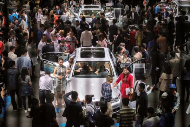 People gather at the BMW stand at this year's Beijing Auto Show