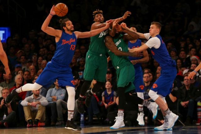 Joakim Noah and Kristaps Porzingis of the New York Knicks pursue the loose ball against Ma