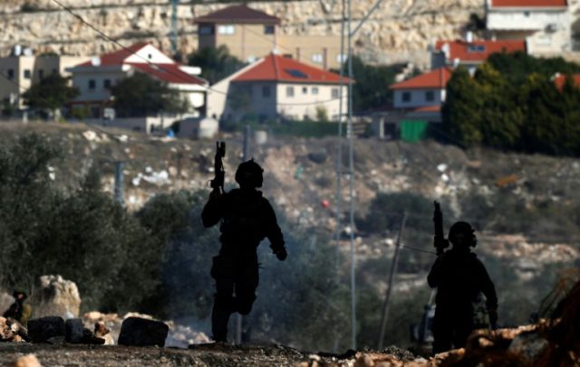 Israeli security forces take position near the settlement of Kadumim (background) during c