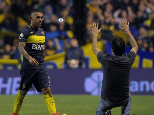 Former Manchester United, Manchester City and Boca Juniors' striker Carlos Tevez (L) has s