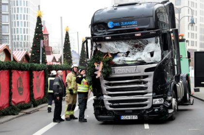 German officials inspect the truck that Anis Amri drove through a packed Berlin Christmas market on December 19, 2016