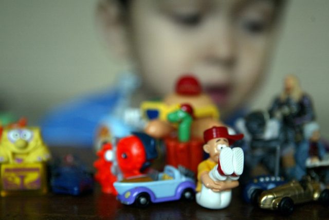 A child plays with toys collected from the famous Kinder Suprise filled chocolate eggs mad