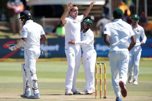 South Africa bowler Kyle Abbott (C, L) and fielder Temba Bavuma (C,R) celebrate the dismis