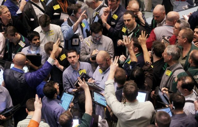 Traders work in the crude oil options pit on the floor of the New York Mercantile Exchange