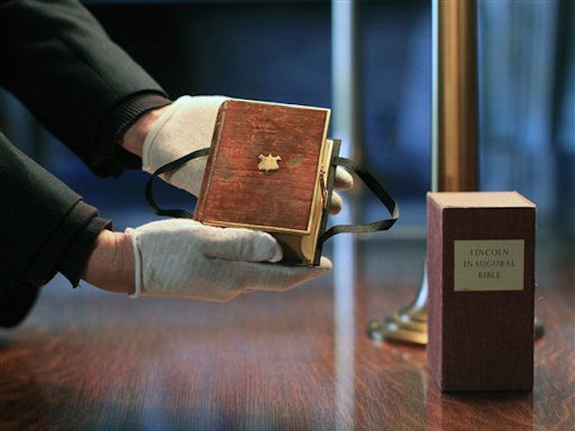 Curator Clark Evans displays the burgundy velvet, gilt-edged Lincoln Inaugural Bible at th