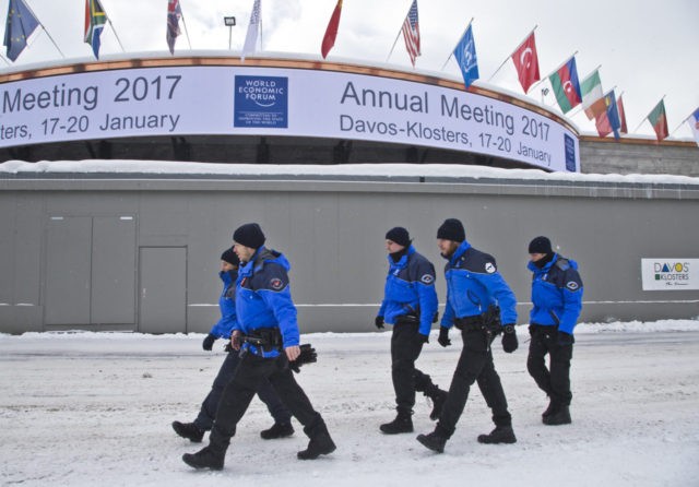 Swiss police officers walk past the congress center where the annual meeting, World Economic Forum, will take place in Davos, Switzerland, Sunday Jan. 15, 2017. Business and world leaders are gathering for the annual meeting in Davos. (AP Photo/Michel Euler)(AP Photo/Michel Euler)
