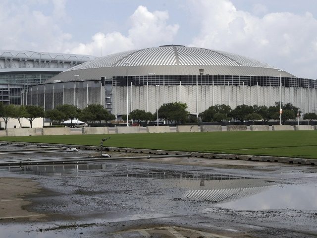 FILE - In this July 30, 2014, file photo, the Houston Astrodome is reflected in a puddle i