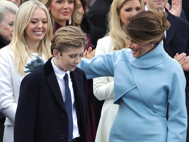 WASHINGTON, DC - JANUARY 20: Melania Trump puts her arm around son Barron Trump on the West Front of the U.S. Capitol on January 20, 2017 in Washington, DC. In today's inauguration ceremony Donald J. Trump becomes the 45th president of the United States. (Photo by Alex Wong/Getty Images)